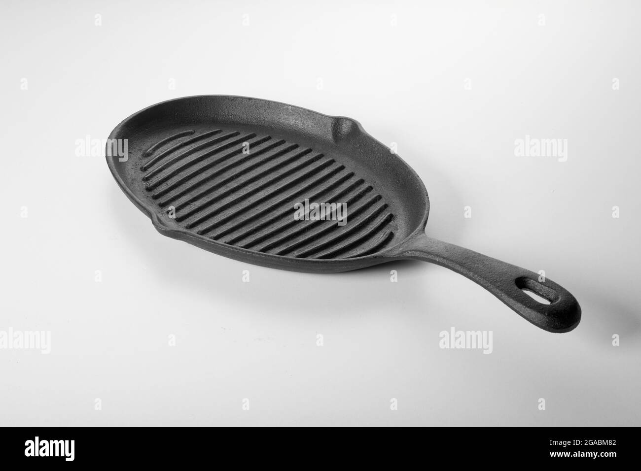 From above of cast iron grill skillet pan with oil drain outlet on