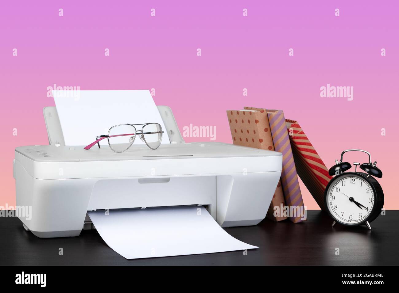 Compact home laser printer against pink background Stock Photo