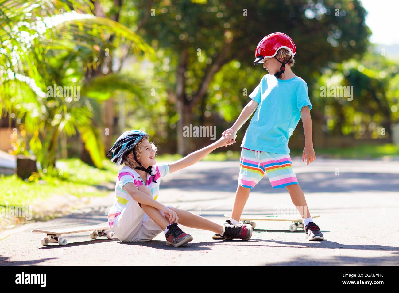 Kids with skate board. Children ride skateboard. Sports safety, fall
