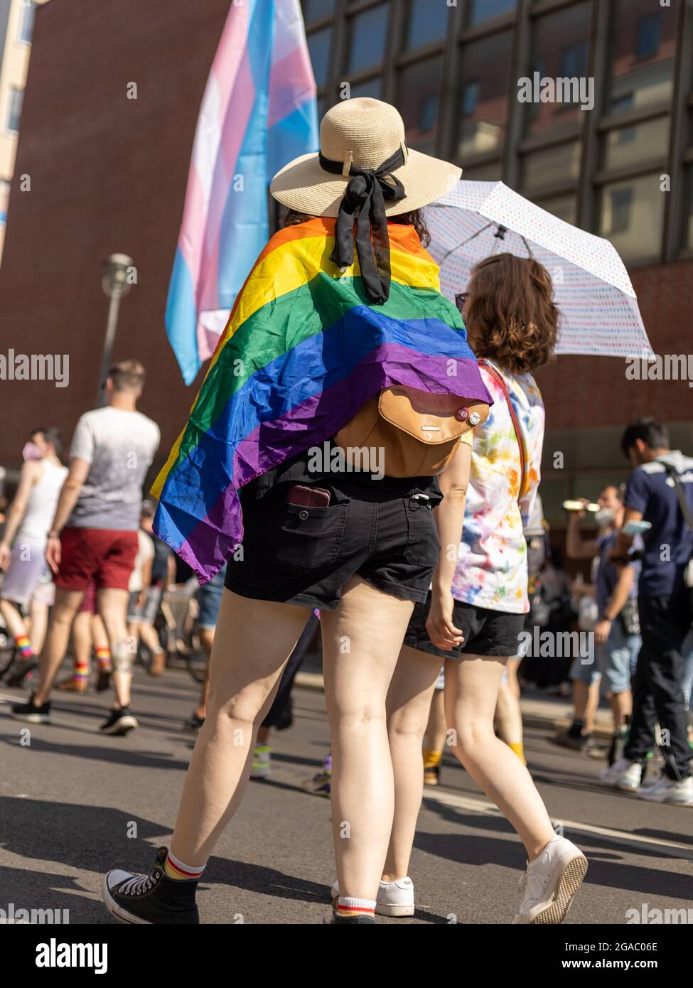 Berlin, Germany - June 26, 2021 - A women carry a rainbow flag on Christopher Street Day (CSD) Stock Photo