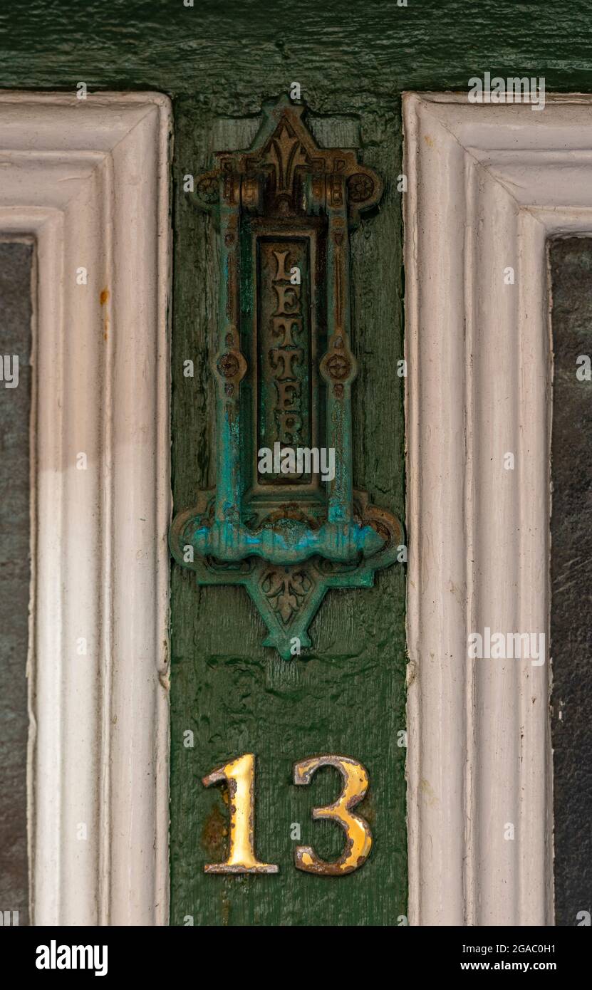 number 13, number thirteen, door number, unlucky number, superstition, superstitious, folklore, myths, luck, fortune, letterbox, doorknocker, entry. Stock Photo