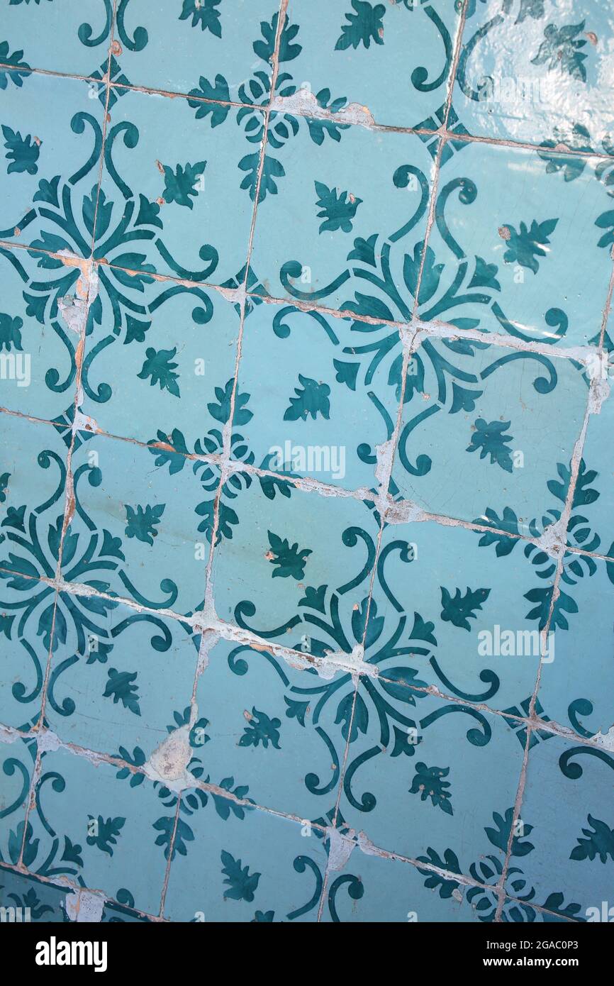Traditional glazed blue and turquoise green or teal ceramic tiles or azulejos which cover many buildings in Lisbon, Portugal. Stock Photo