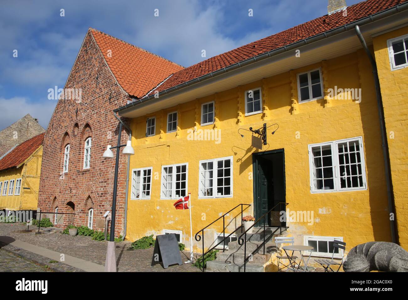 Beautiful historic building which is brick built and partially painted yellow, which is a landmark in Kalundborg, Denmark. Stock Photo