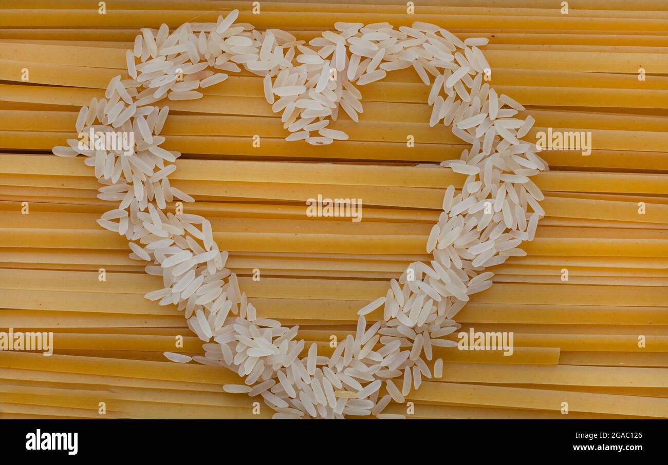 raw pasta with heart of rice grains Stock Photo - Alamy