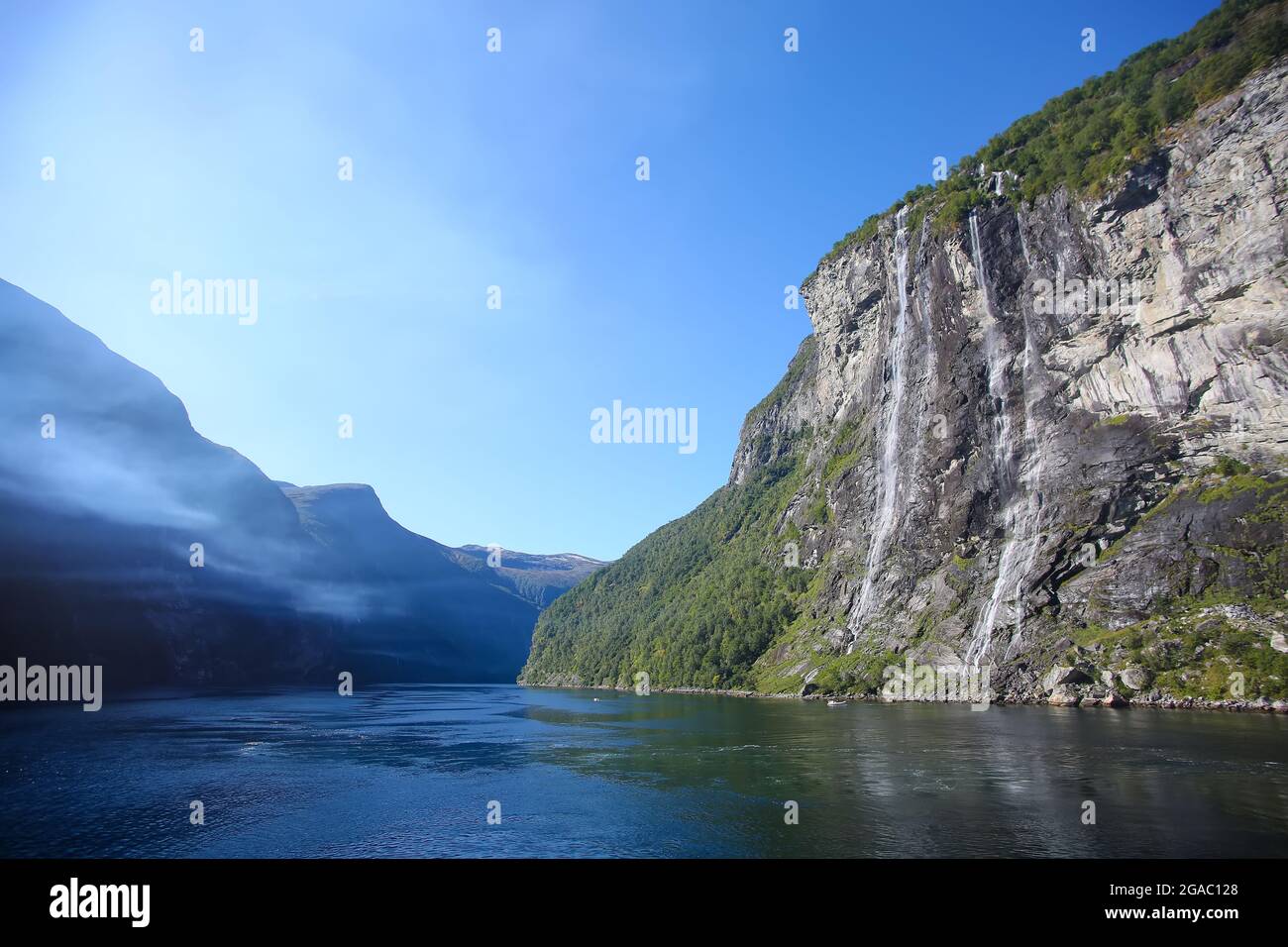 The Seven Sisters waterfall which is one of the tallest in Norway.  Beautiful fjord landscape with cliffs either side. Geirangerfjord, Norway. Stock Photo
