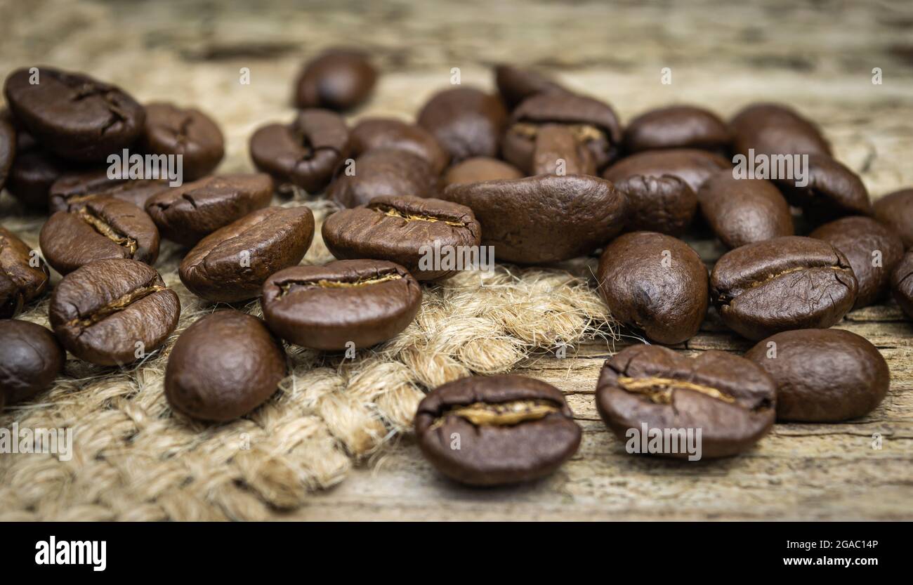 coffee beans on old natural wood background close up Stock Photo