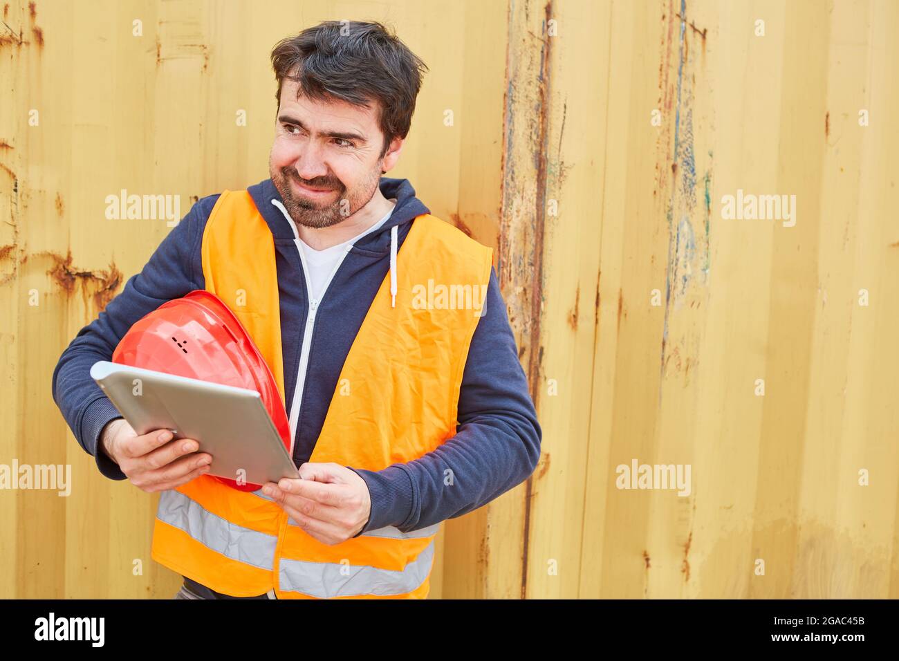Craftsman or architect in safety vest with tablet computer during construction project planning Stock Photo