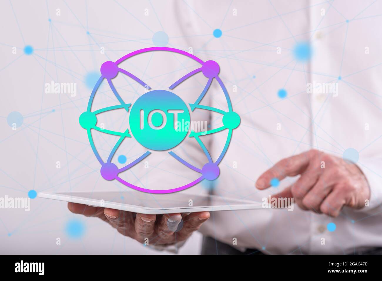 Iot concept above a tablet held by a man in background Stock Photo