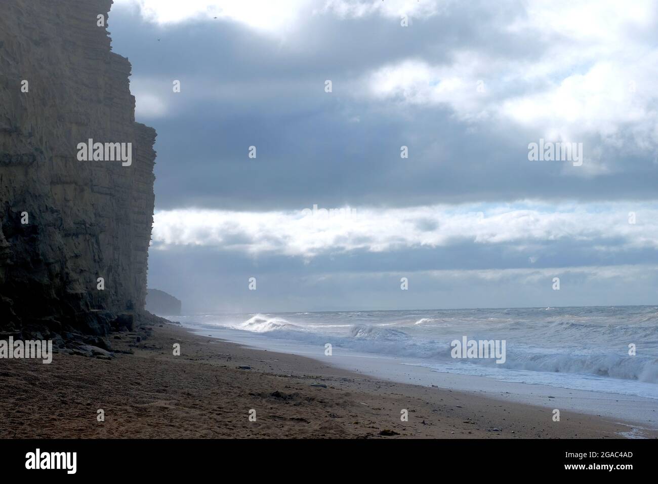 West Bay, Dorset, UK. 30th July, 2021. After a night of high winds waves build up on the Dorset coast at West Bay as Storm Evert hits the South West. Credit: Tom Corban/Alamy Live News Stock Photo