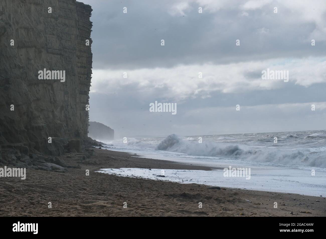 West Bay, Dorset, UK. 30th July, 2021. After a night of high winds waves build up on the Dorset coast at West Bay as Storm Evert hits the South West. Credit: Tom Corban/Alamy Live News Stock Photo