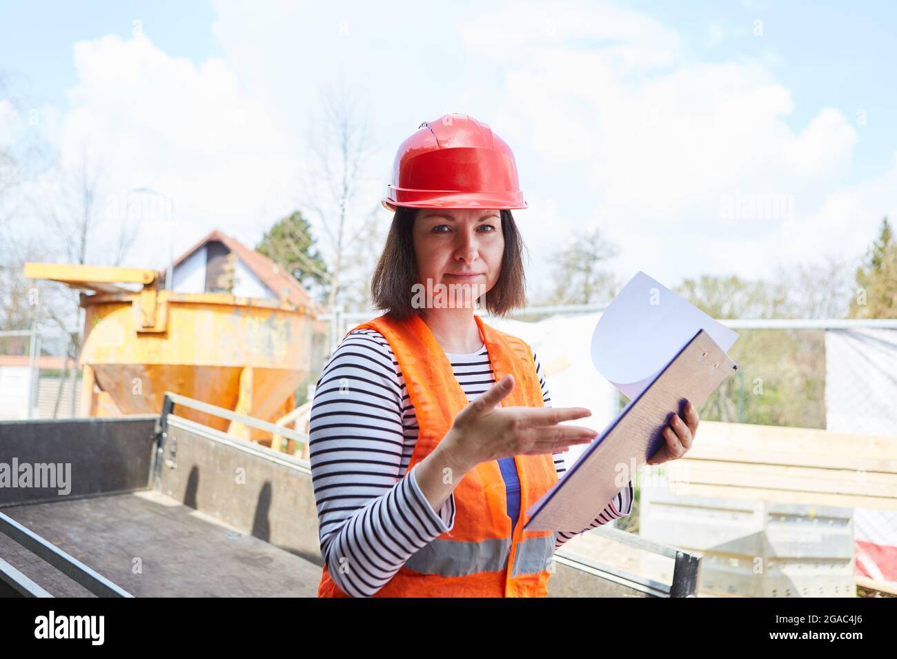 Architect with test report on clipboard as construction manager on the construction site for a new building Stock Photo