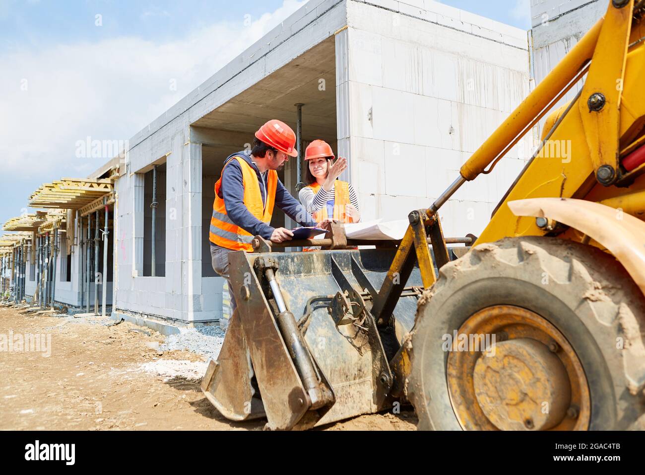 Foreman and architect on the construction site in the shell construction together during the construction project planning Stock Photo