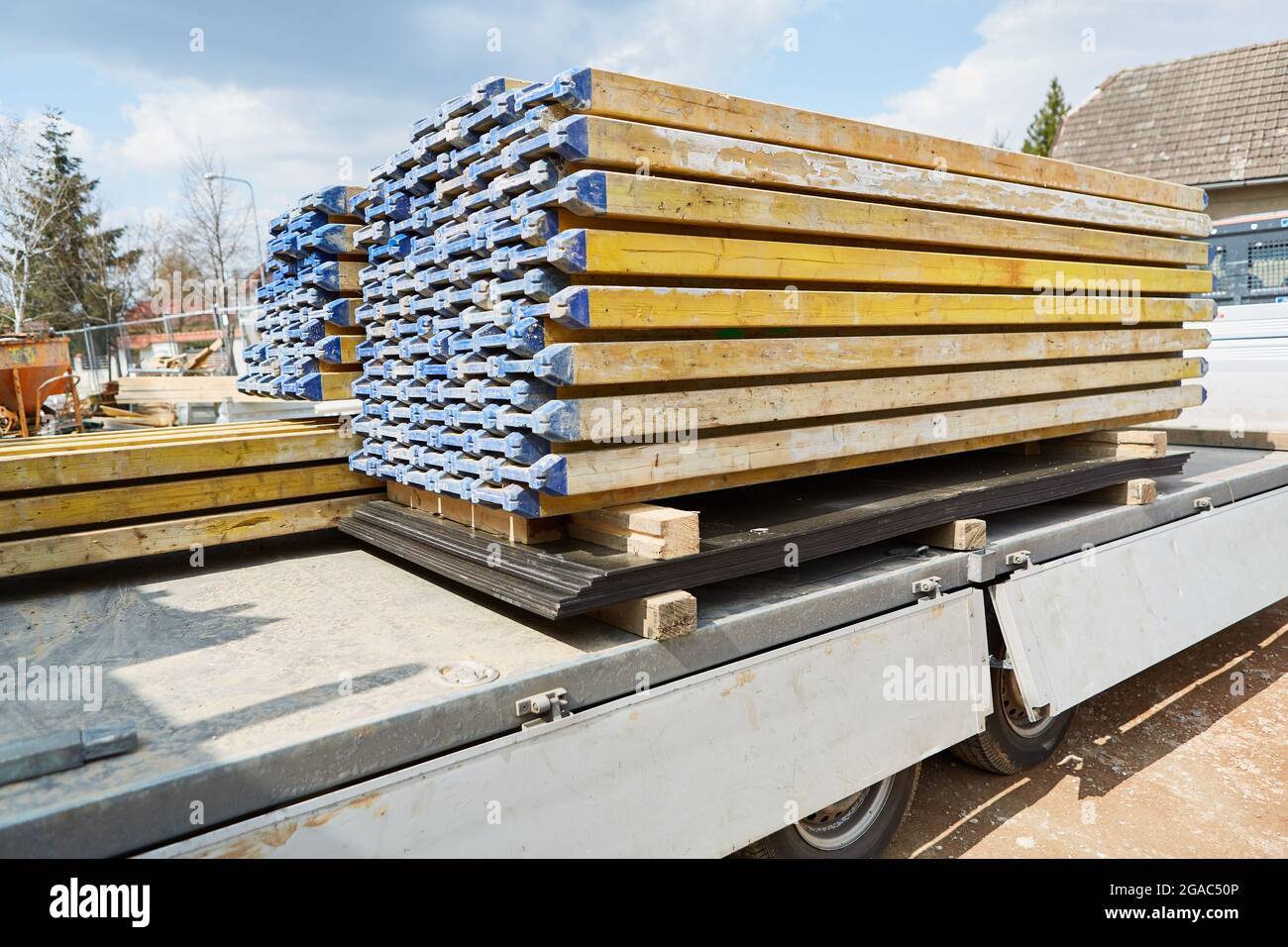 Building materials stacked on the back of a truck at a construction site for house building Stock Photo