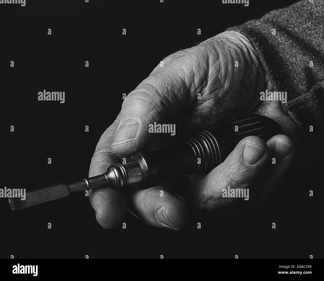 Hand with tool Stock Photo - Alamy