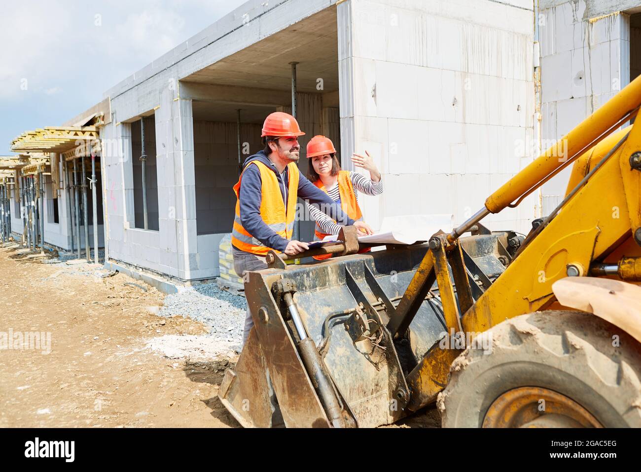 Architect and foreman on the new construction site in the shell construction when planning the construction work Stock Photo