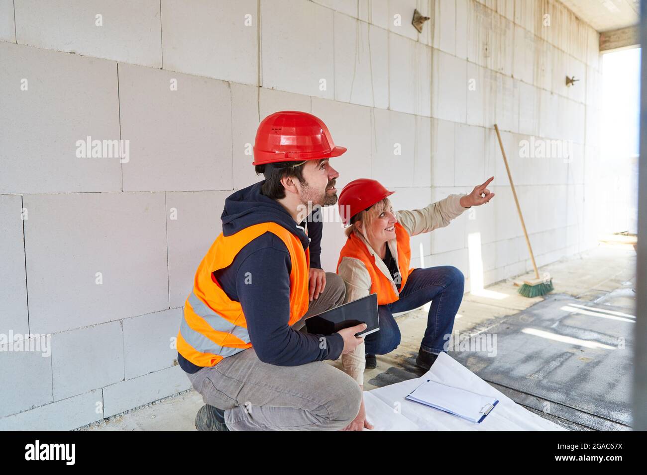 The architect and foreman work together in planning the construction of the house Stock Photo