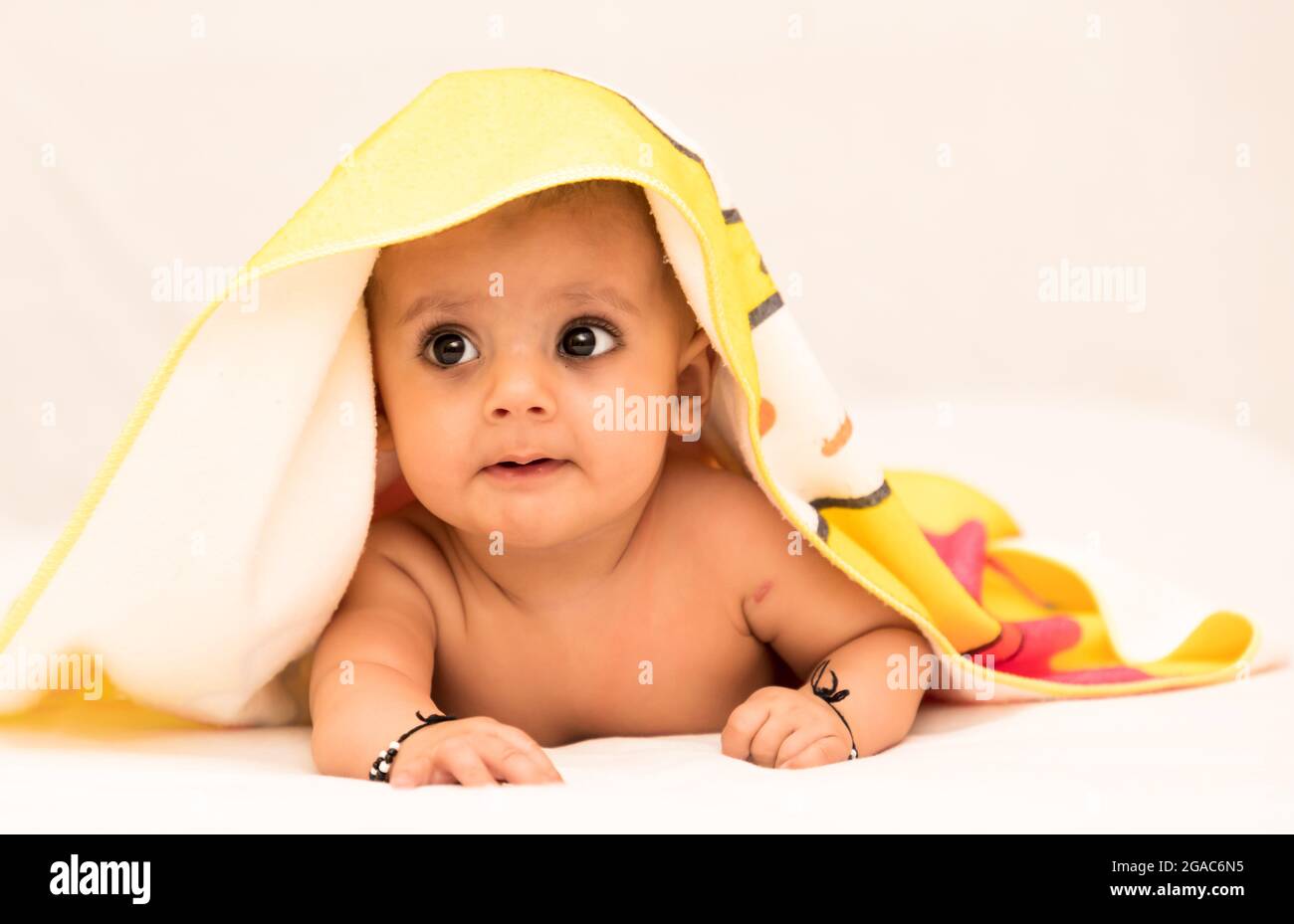 close up photo shoot of a indian baby girl covered with blanket Stock
