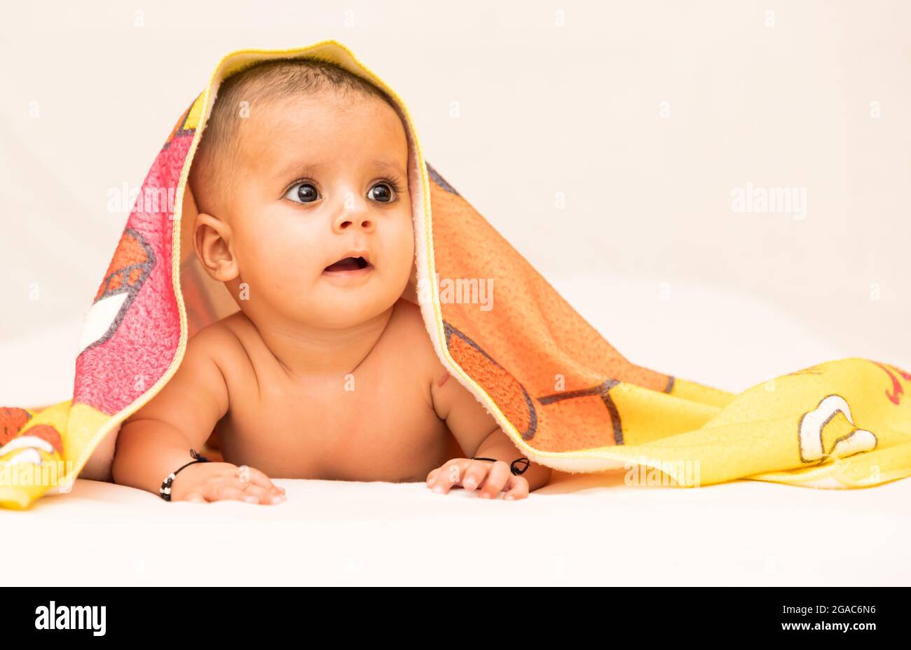 close up photo shoot of a indian baby girl covered with blanket Stock