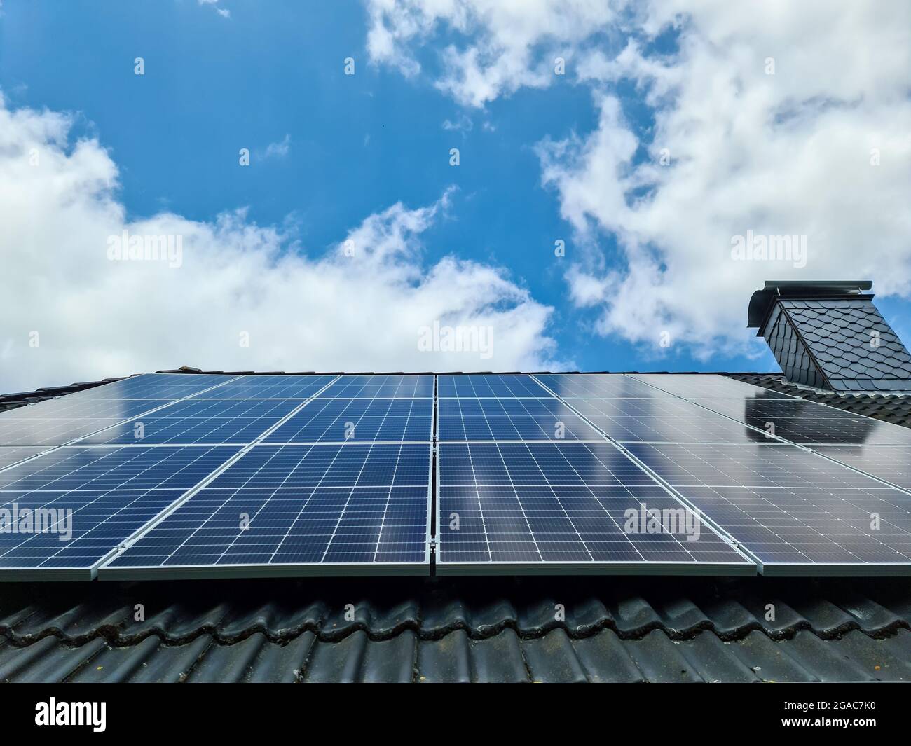 Solar panels producing clean energy on a roof of a residential house ...