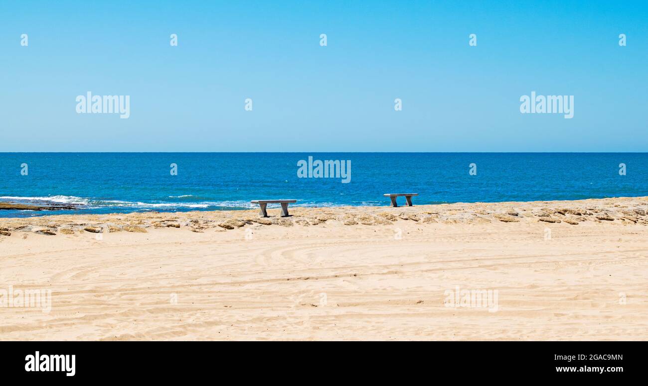 Promenade with benches on the beach at Costilla de Rota, Cadiz, Andalusia, Spain Stock Photo