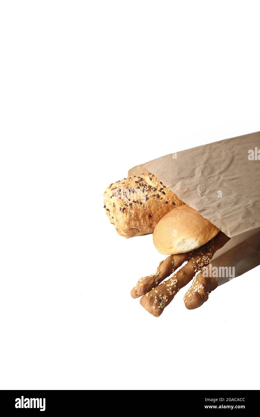 bread in paper bag isolated on white background. Image contains copy
