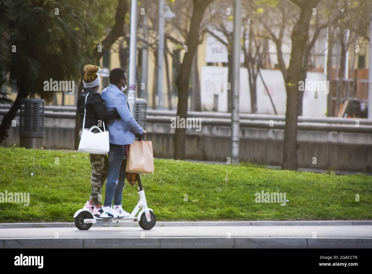 Couple riding on a electric scooter. Stock Photo
