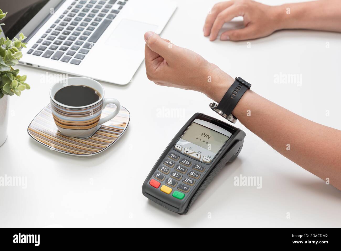 Man pays by a smart watch in a cafe restaruant. Contactless, convenient form of payment Stock Photo