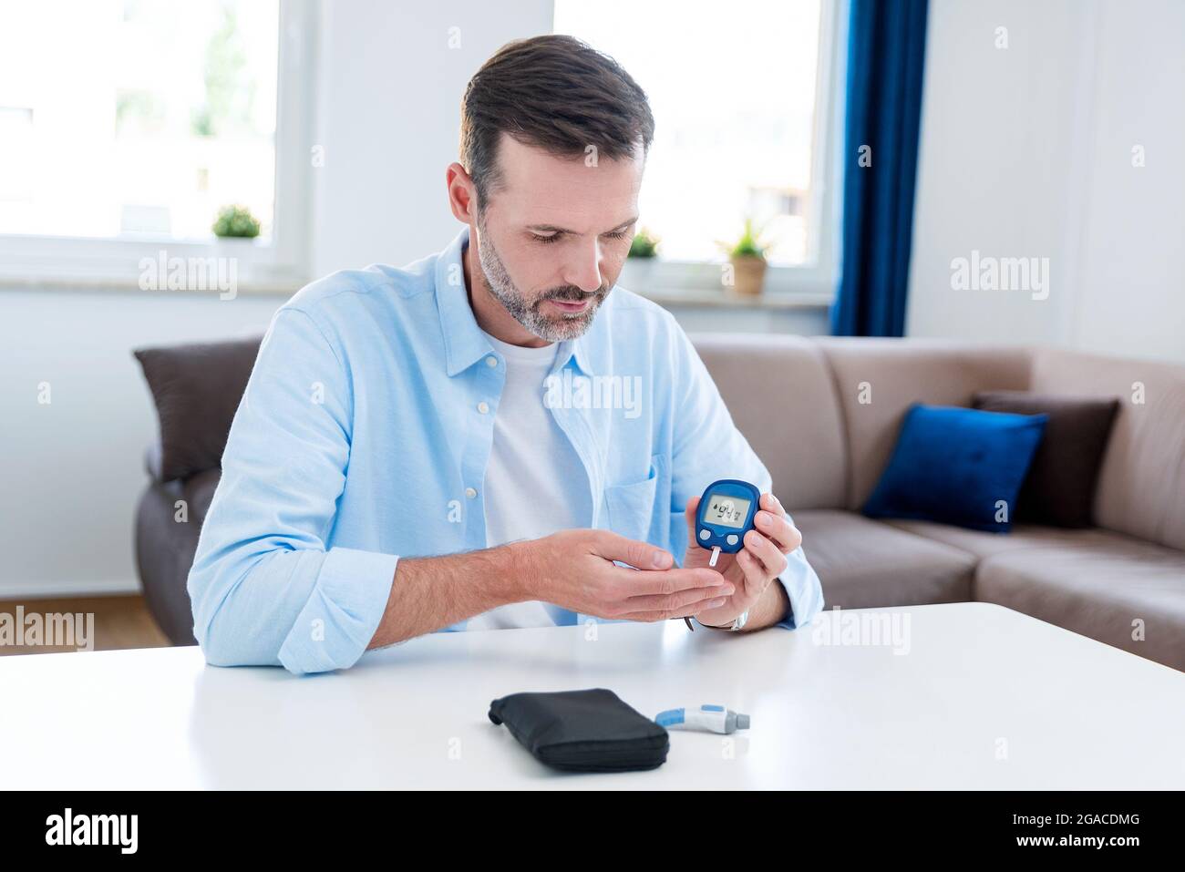 Man Using Glucometer Glucometer testing hi-res stock photography and images - Alamy