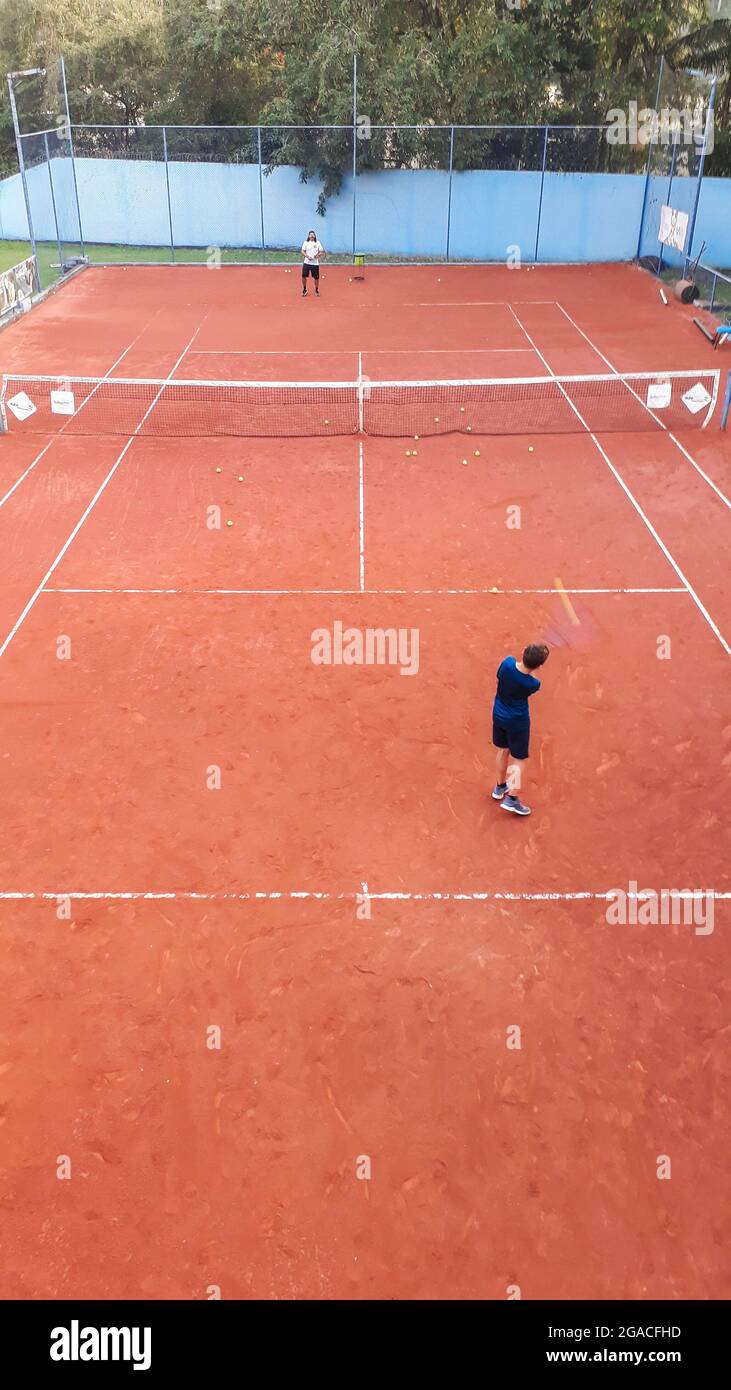 VOLTA REDONDA, BRAZIL - Jun 01, 2021: A boy playing tennis on a clay court  Stock Photo - Alamy