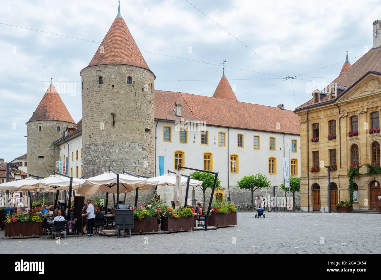 Yverdons-les-bains, Switzerland - July 11th 2021: Historic facades, a restaurant and the tower in the city centre Stock Photo