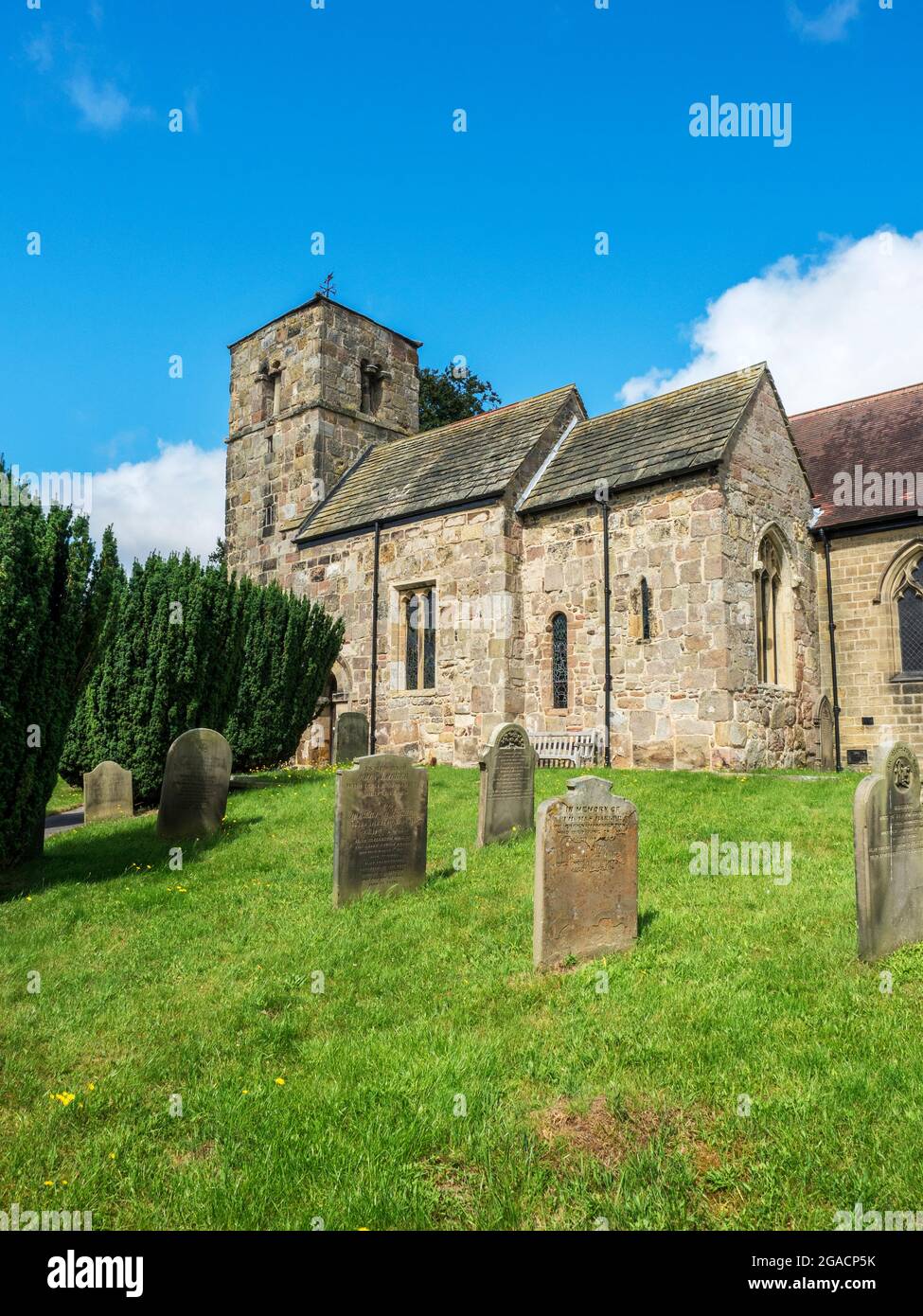 The 11th century or earlier grade I listed Church of St John the Baptist at Kirk Hammerton North Yorkshire England Stock Photo