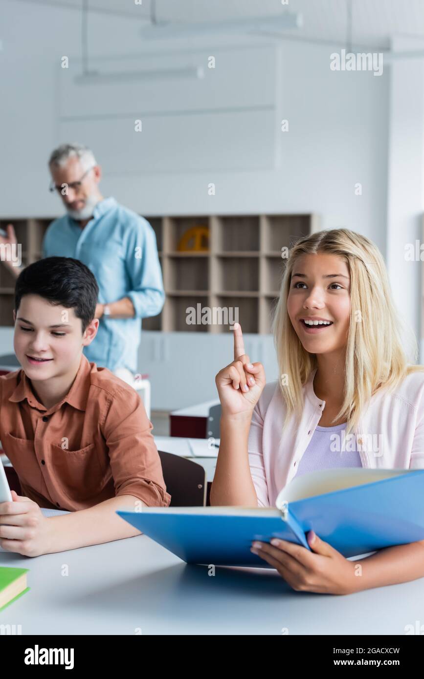 School children holding books in library Stock Photo - Alamy