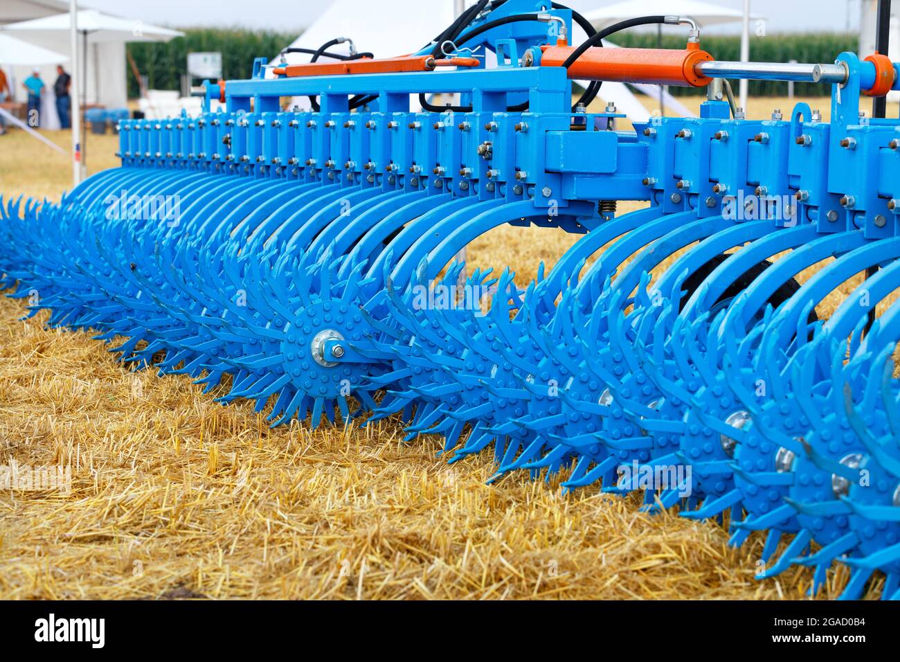 A multi-row toothed metal harrow of blue color for a tractor hitch for  agricultural processing of fields. Selective focus, copy space Stock Photo  - Alamy