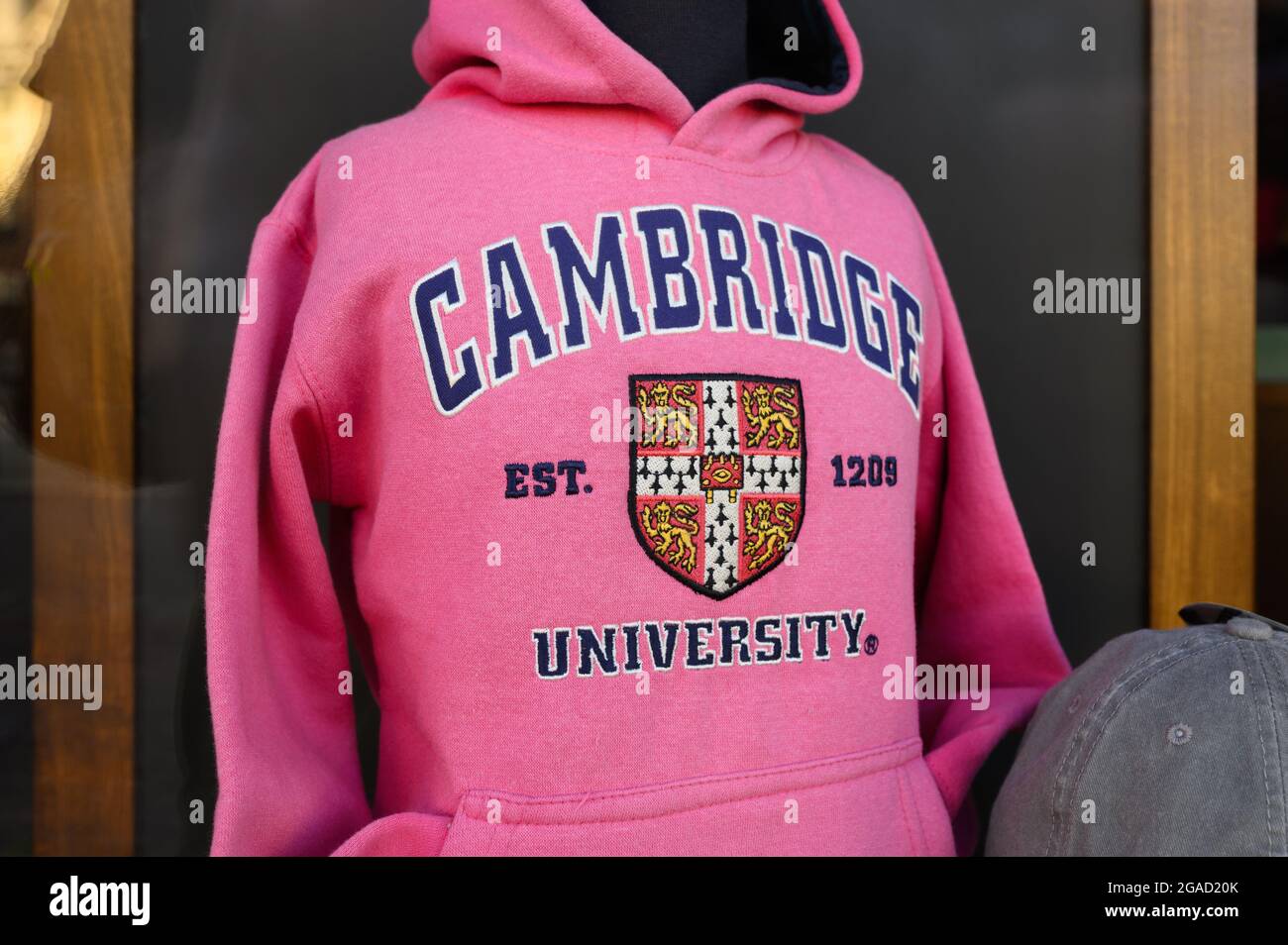 Pink University of Cambridge hoodie or sweatshirt in a shop window. Stock Photo