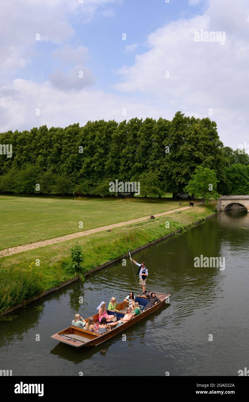 Tourists punting on the River Cam in Cambridge, England, with Trinity Bridge visible in the background. Stock Photo