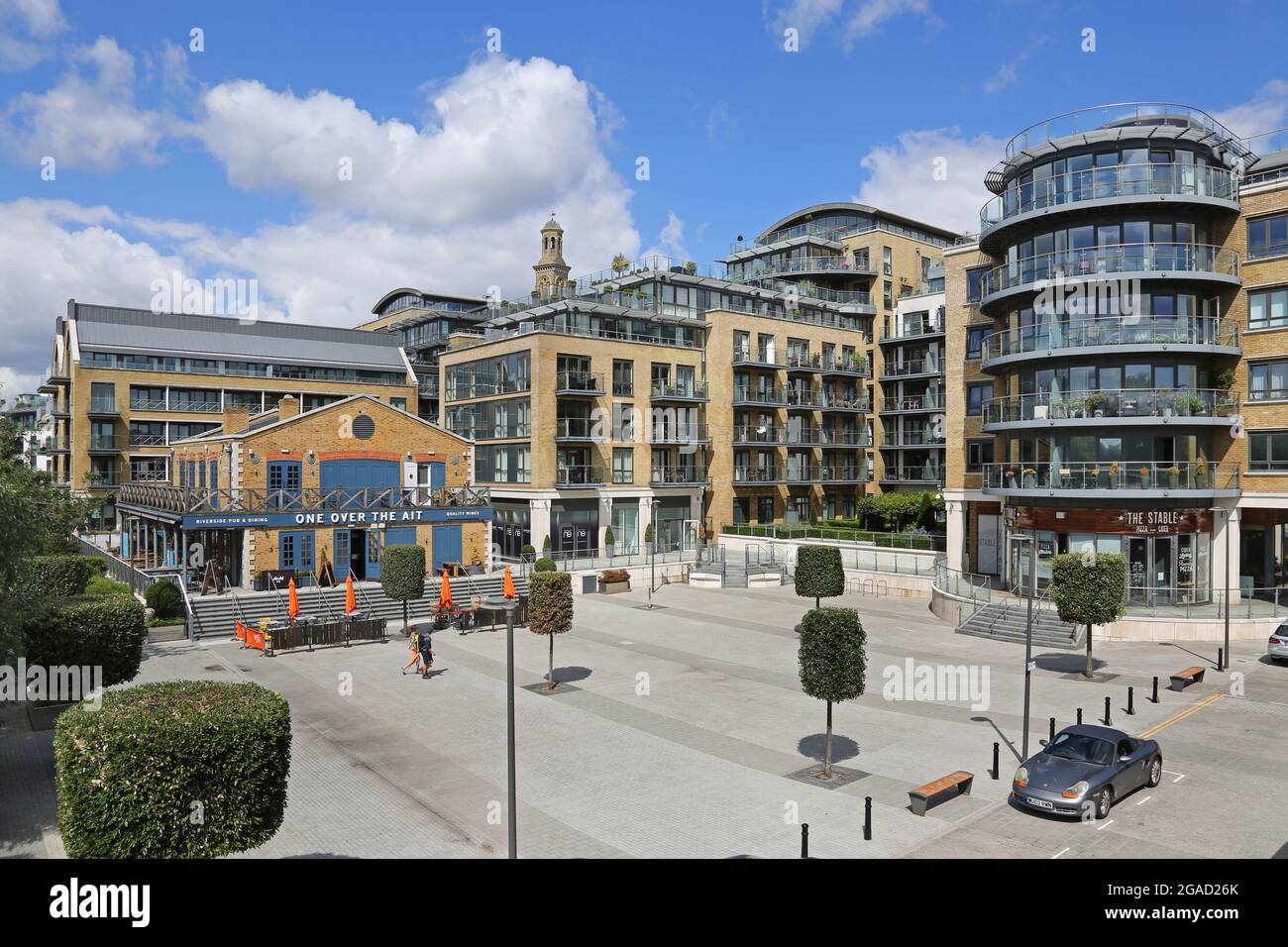 New riverside residential development at Kew Bridge, west London, by the River Thames. Shows One Over The Ait cafe/bar with apartment blocks beyond. Stock Photo