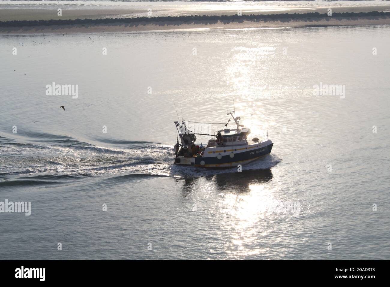 fishing boat returning to harbor Stock Photo - Alamy