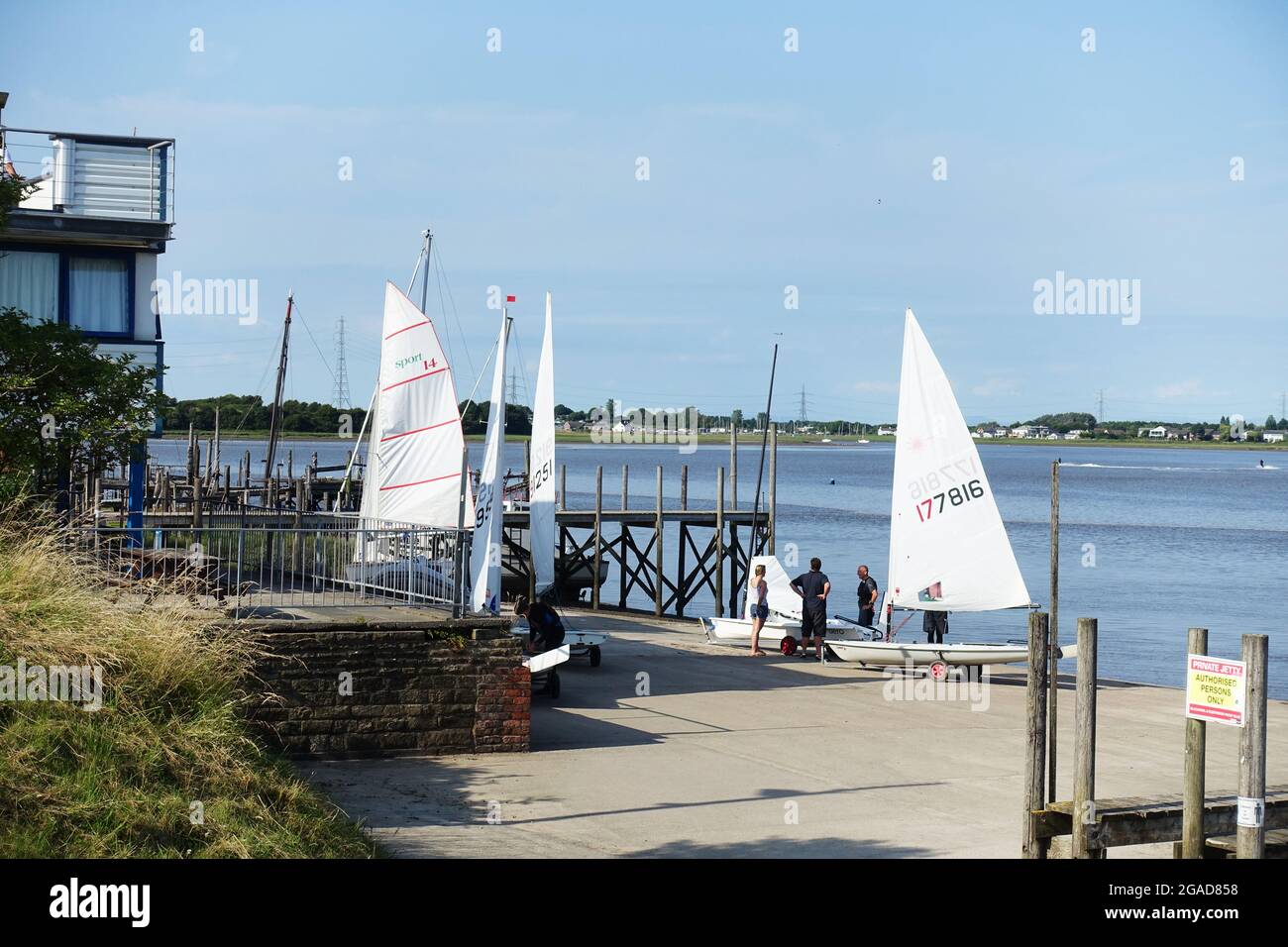 Sailing dinghies preparing for a race at the Blackwood and Fleetwood Yacht Club on the River Wyre Stock Photo