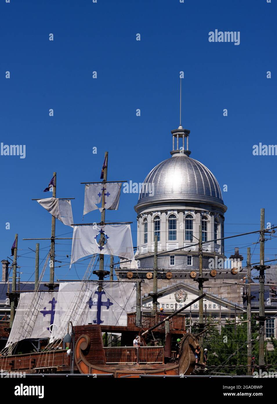 The Montreal Old Port (Le Vieux Port) with the dome of Marché Bonsecours and the Voiles en Voiles pirate ship adventure Stock Photo