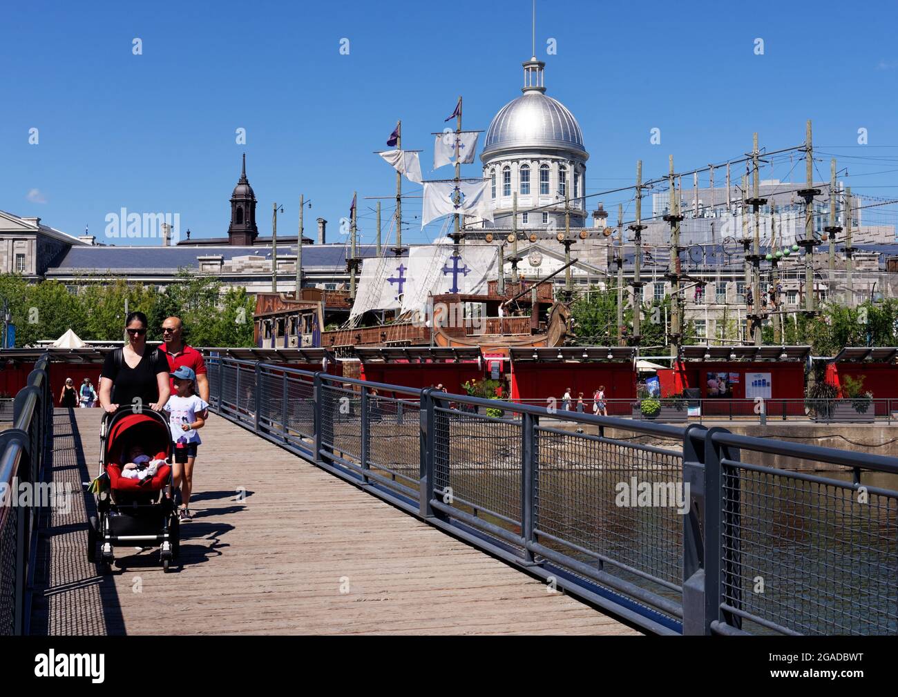 The Montreal Old Port (Le Vieux Port) with the dome of Marché Bonsecours and the Voiles en Voiles pirate ship adventure Stock Photo