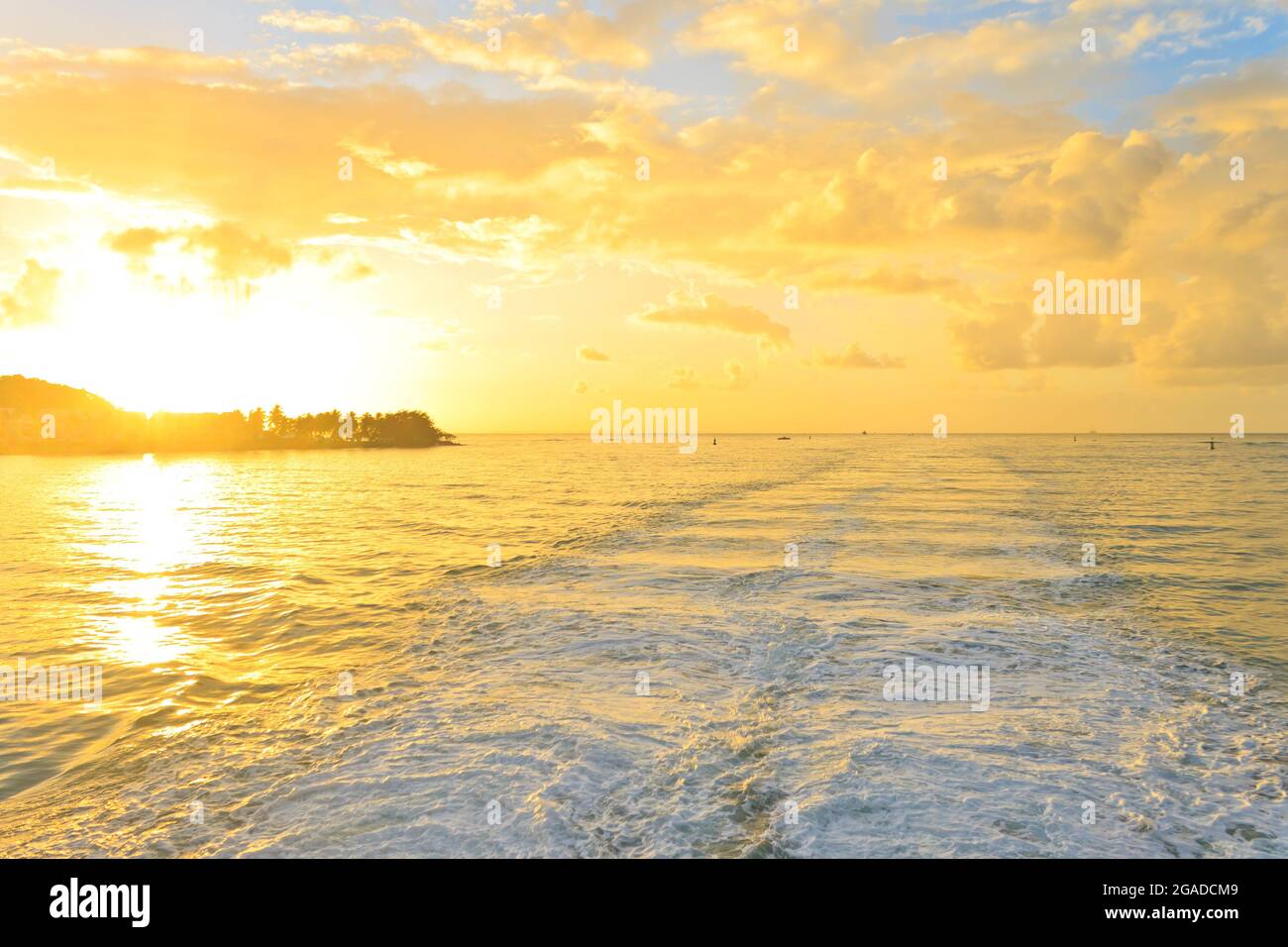Breathtaking tropical sunrise contrasted with the wave wake Stock Photo