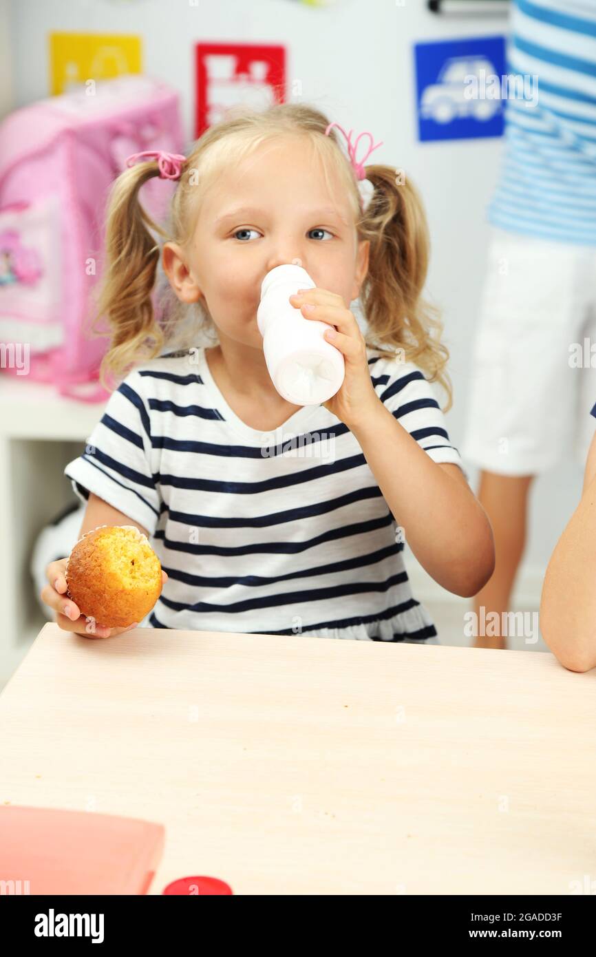 Cute girl at lunch time in classroom Stock Photo Alamy