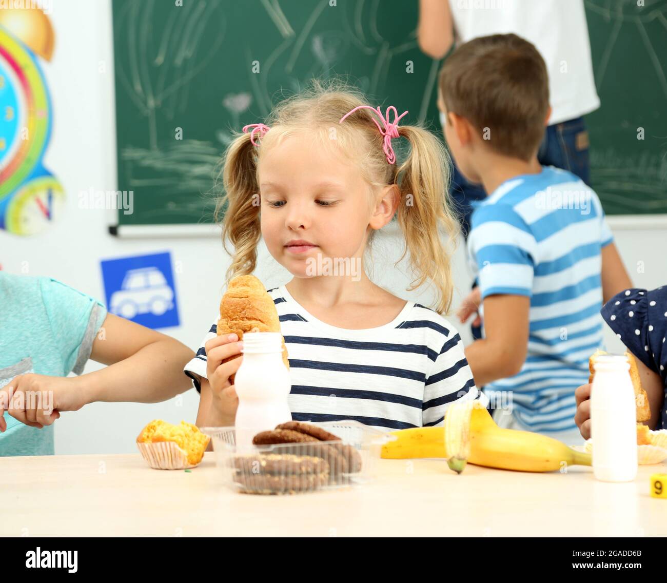 Cute children at lunch time in classroom Stock Photo Alamy