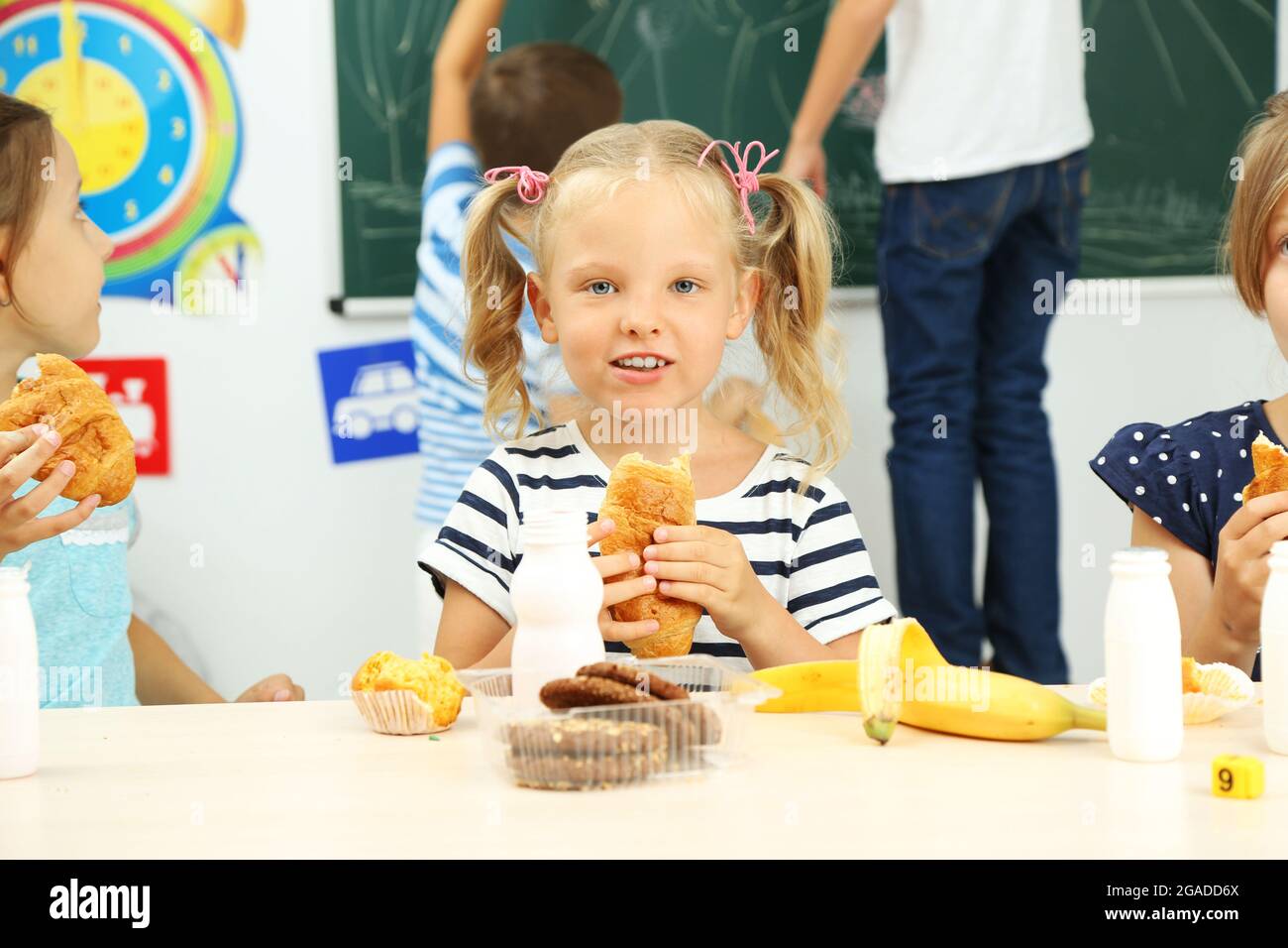Cute girl at lunch time in classroom Stock Photo Alamy