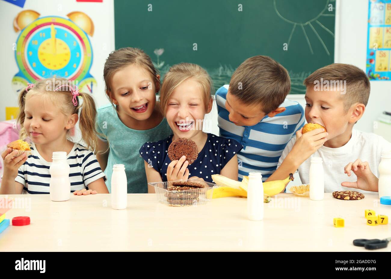 Cute children at lunch time in classroom Stock Photo Alamy