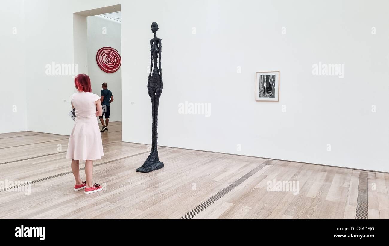 Female visitor in a room with Giacometti sculpture works in Fondation Beyeler in Riehen, Switzerland. Stock Photo