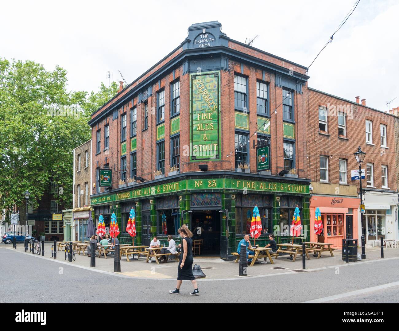 People relaxing and enjoying a drink seated at pavement tables outside ...