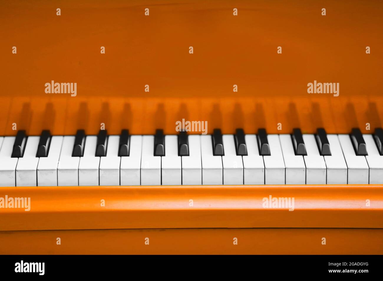 Piano keys of orange piano close up Stock Photo Alamy