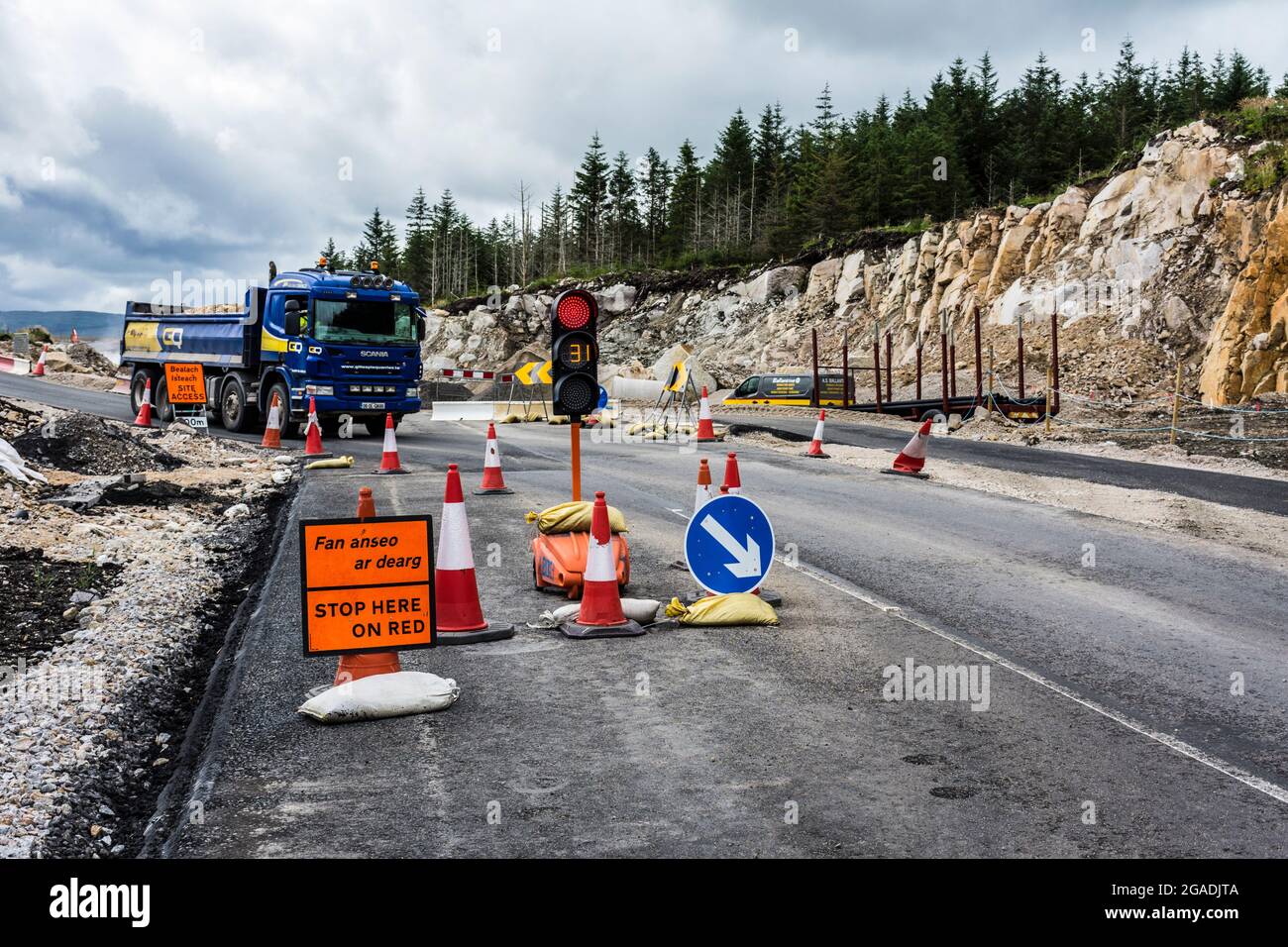 Roadworks traffic lights in Gaelic Irish and English language. N56 road near Dungloe, County Donegal, Ireland Stock Photo