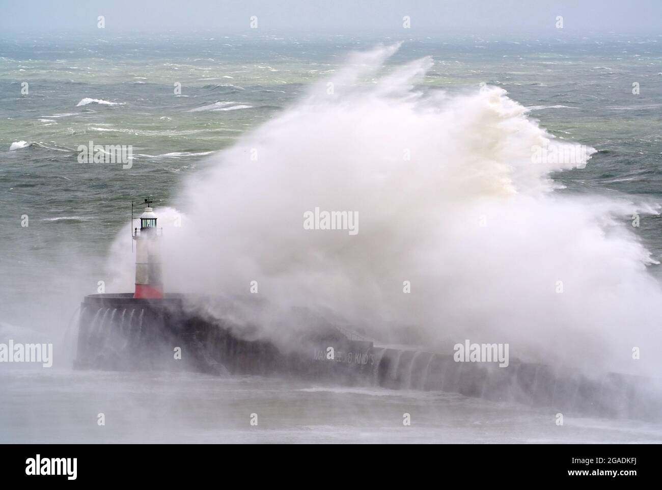 Newhaven, East Sussex, UK. 30th July, 2021. Waves crash over Newhaven's Breakwater as Storm Evert brings rough seas to the south coast. East Sussex. Credit: Peter Cripps/Alamy Live News Stock Photo